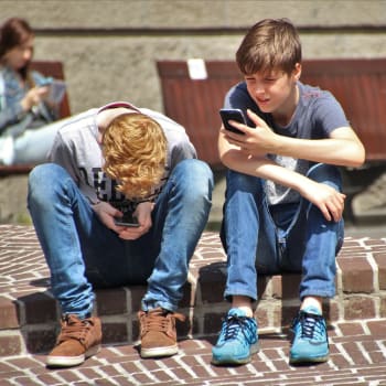 Děti hrající si na mobilech
