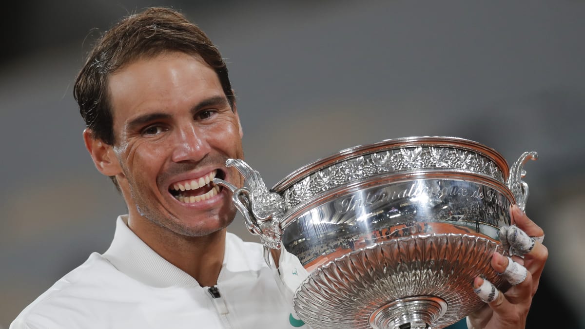 Španělský tenista Rafael Nadal se zakousl do trofeje, když slavil vítězství ve finálovém zápase tenisového turnaje French Open proti Srbovi Novaku Djokovičovi.