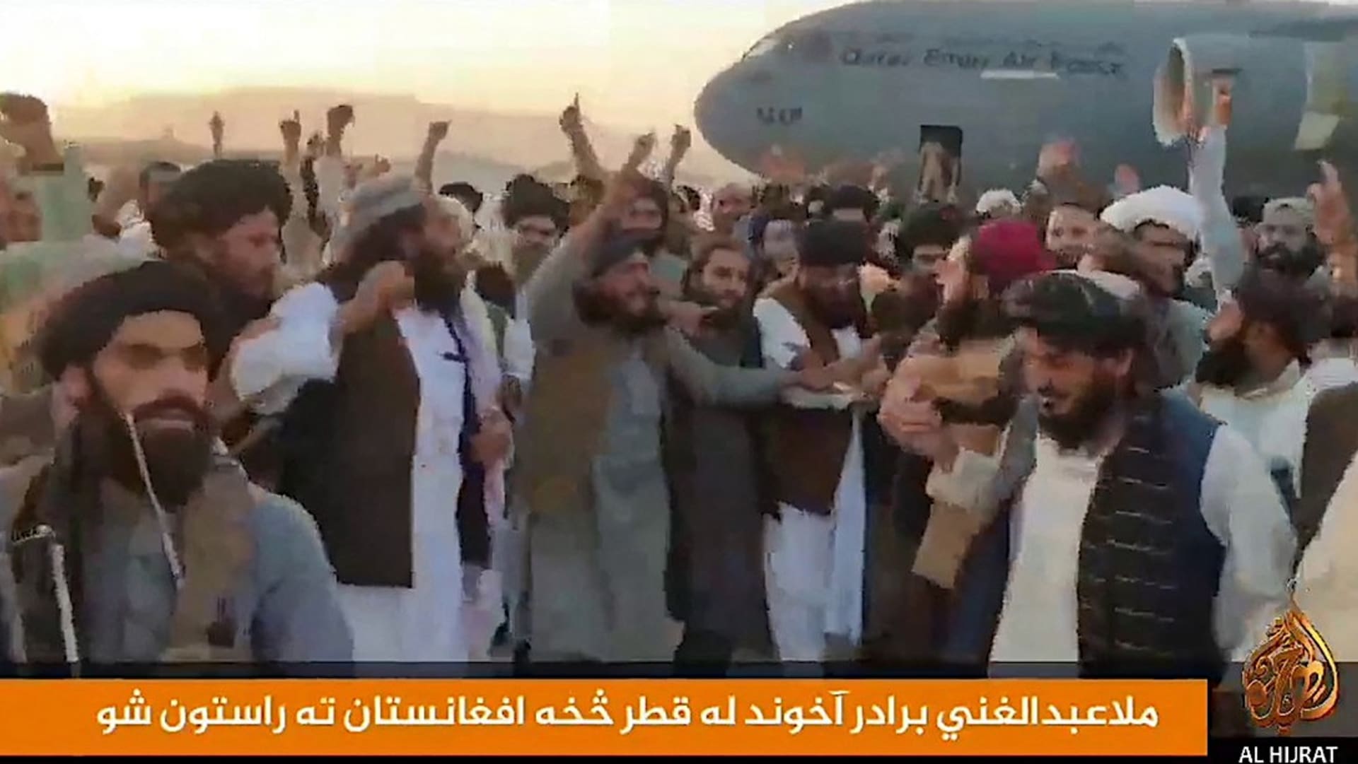 Členové Tálibánu vítají na letišti v Kandaháru svého politického vůdce mullu Baradara, který vstoupil z boeingu Qatar Emiri Air Force.