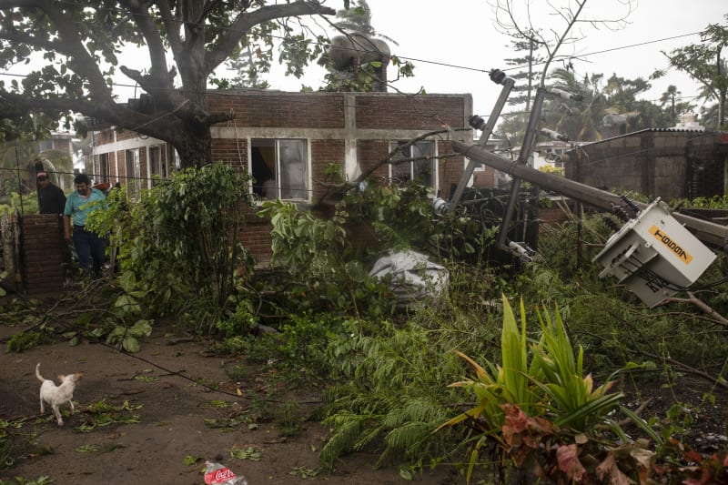 Řádění hurikánu Grace: materiální škody na budovách, popadané stromy a zaplavená auta.