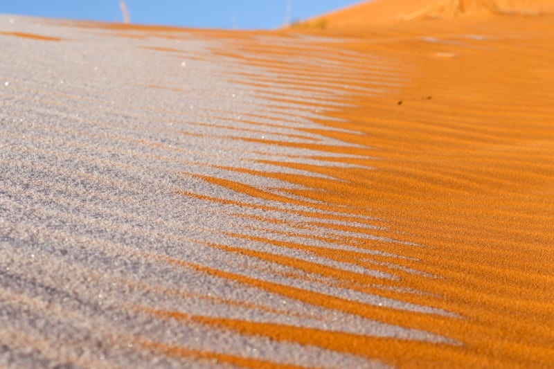 Sněhový poprašek na písku vytvořil ohromující obrazce. 