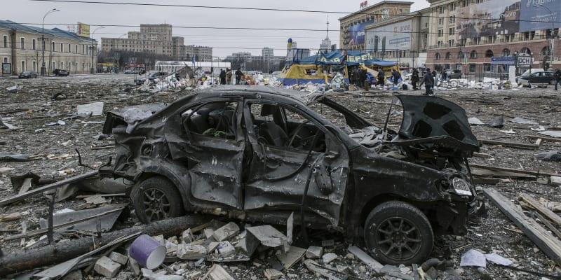 Poškozený automobil na centrálním náměstí po ostřelování budovy radnice v ukrajinském Charkově v úterý 1. března 2022