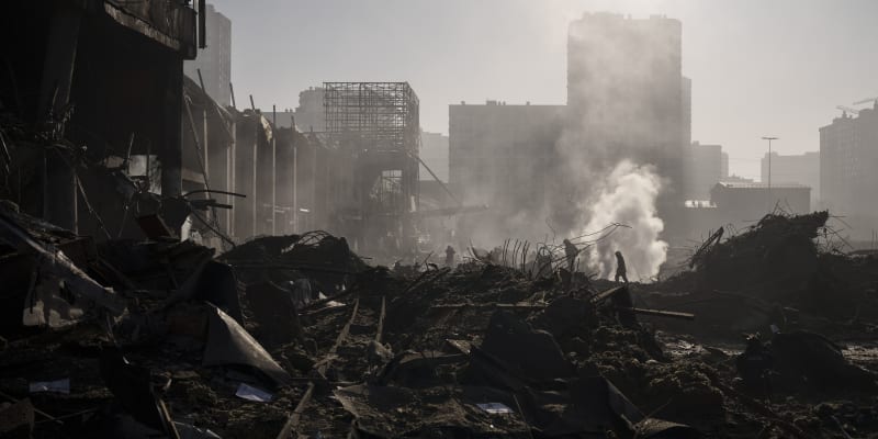 Hasiči hasí požár u nákupního centra po ostřelování Kyjeva (21. března 2022).