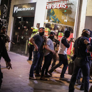 Policisté v civilu zasahují na místě teroristického útoku v Tel Avivu.