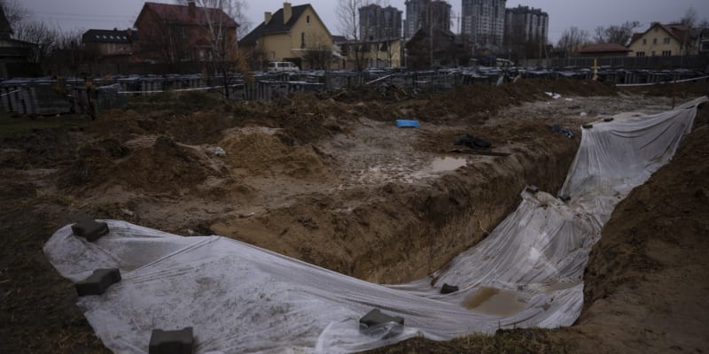 Plachta zakrývající masový hrob v Buči (10. duben)