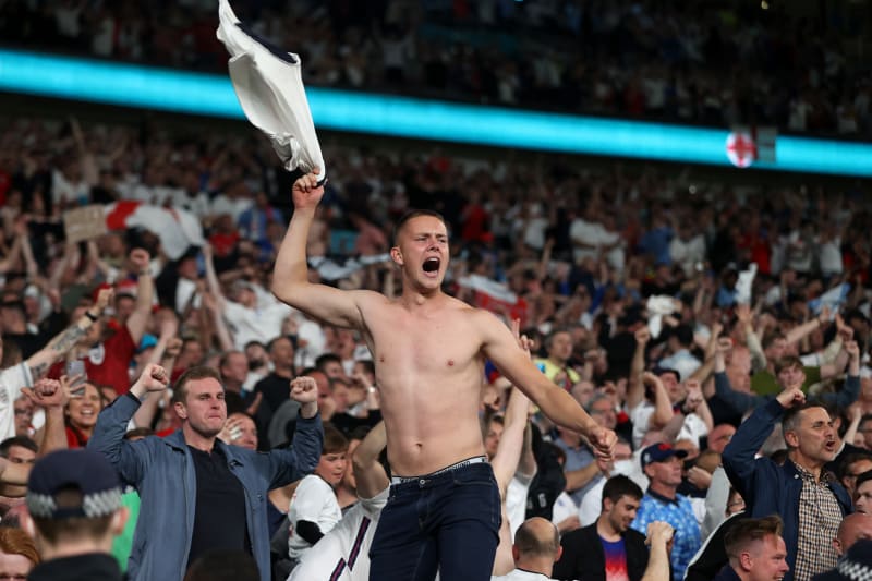 Anglický fanoušek oslavuje druhý gól svého týmu, který vstřelil Harry Kane během semifinálového zápasu mistrovství Evropy 2020 mezi Anglií a Dánskem na stadionu ve Wembley.