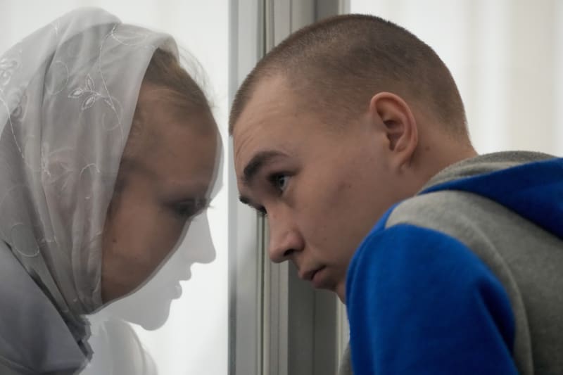 Překladatelka sděluje 21letému ruskému vojáku rozsudek kyjevského soudu. 