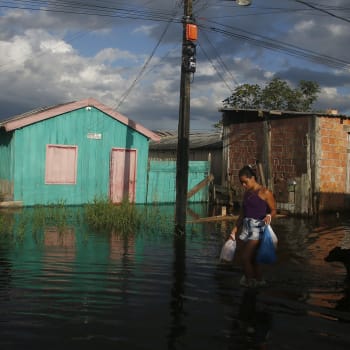 Žena v ulici zaplavené stoupající hladinou řeky Negro v Irandubě v brazilském státě Amazonas. Snímek z pondělí 23. května 2022. 