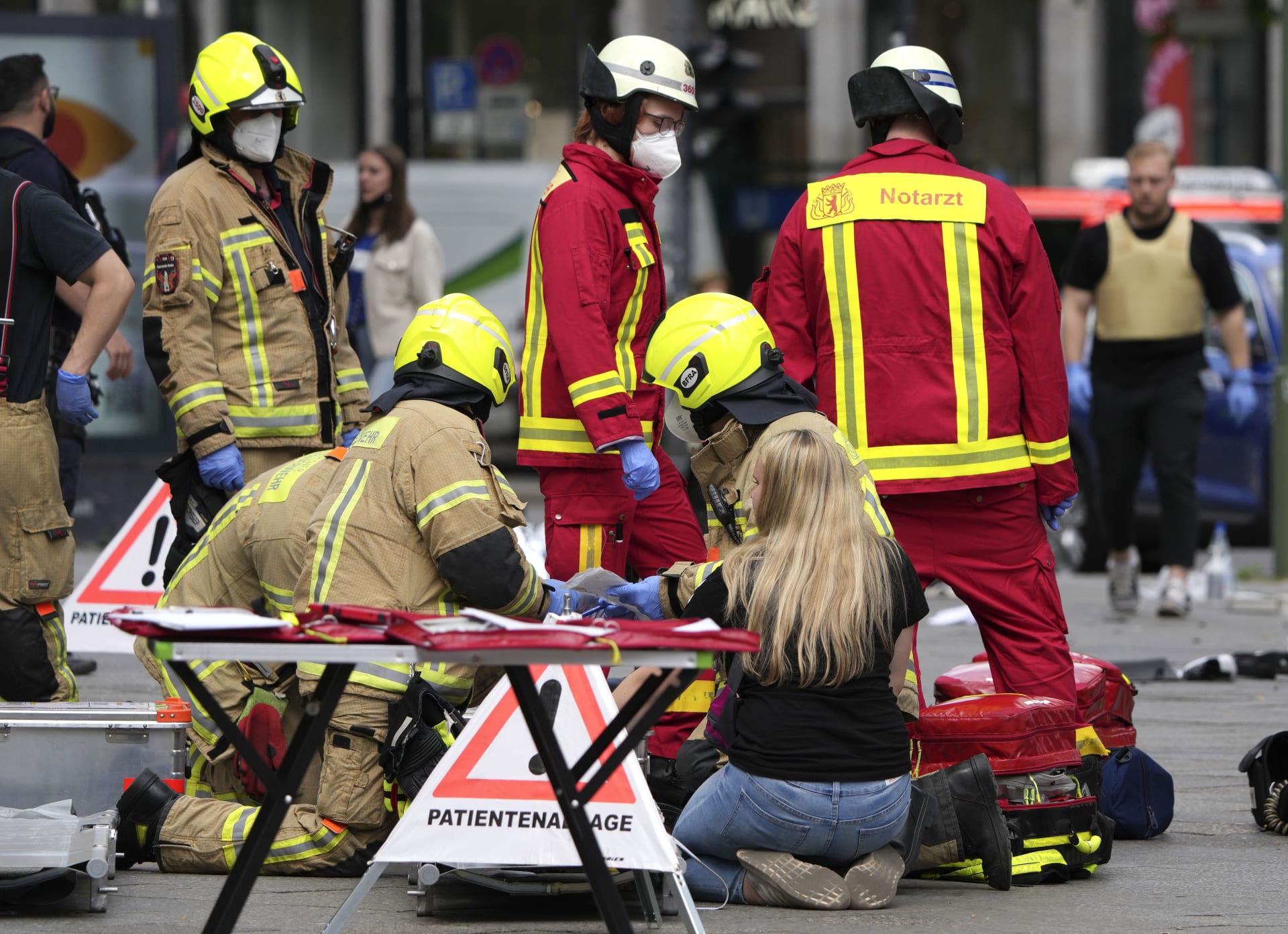  Záchranáři pomáhají zraněnému po nárazu auta do davu lidí v centru Berlína.