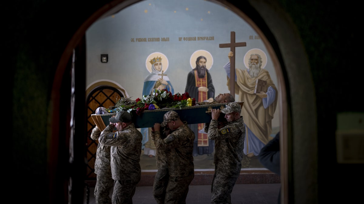 Ukrajinci poklekli před kolonou s padlými vojáky. (Ilustrační foto)