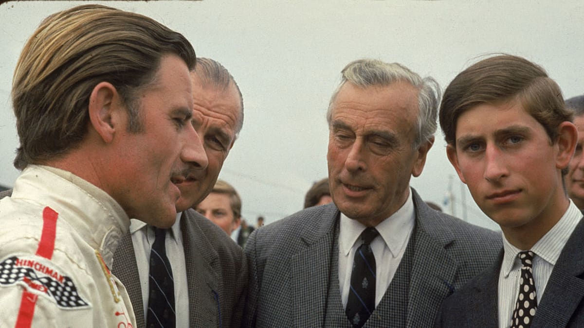S Grahamem Hillem, legendárním britským jezdcem formule 1. Charlesovi dával lekce rychlé jízdy, naslouchá i Lord Mountbatten (uprostřed).