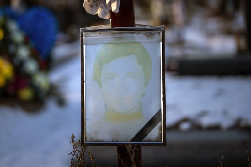 Vybledlý portrét 52leté Oleny Serhiivny na jejím hrobě v Kyjevě. Pohřbena byla 4. dubna 2022. (9.2.2023)