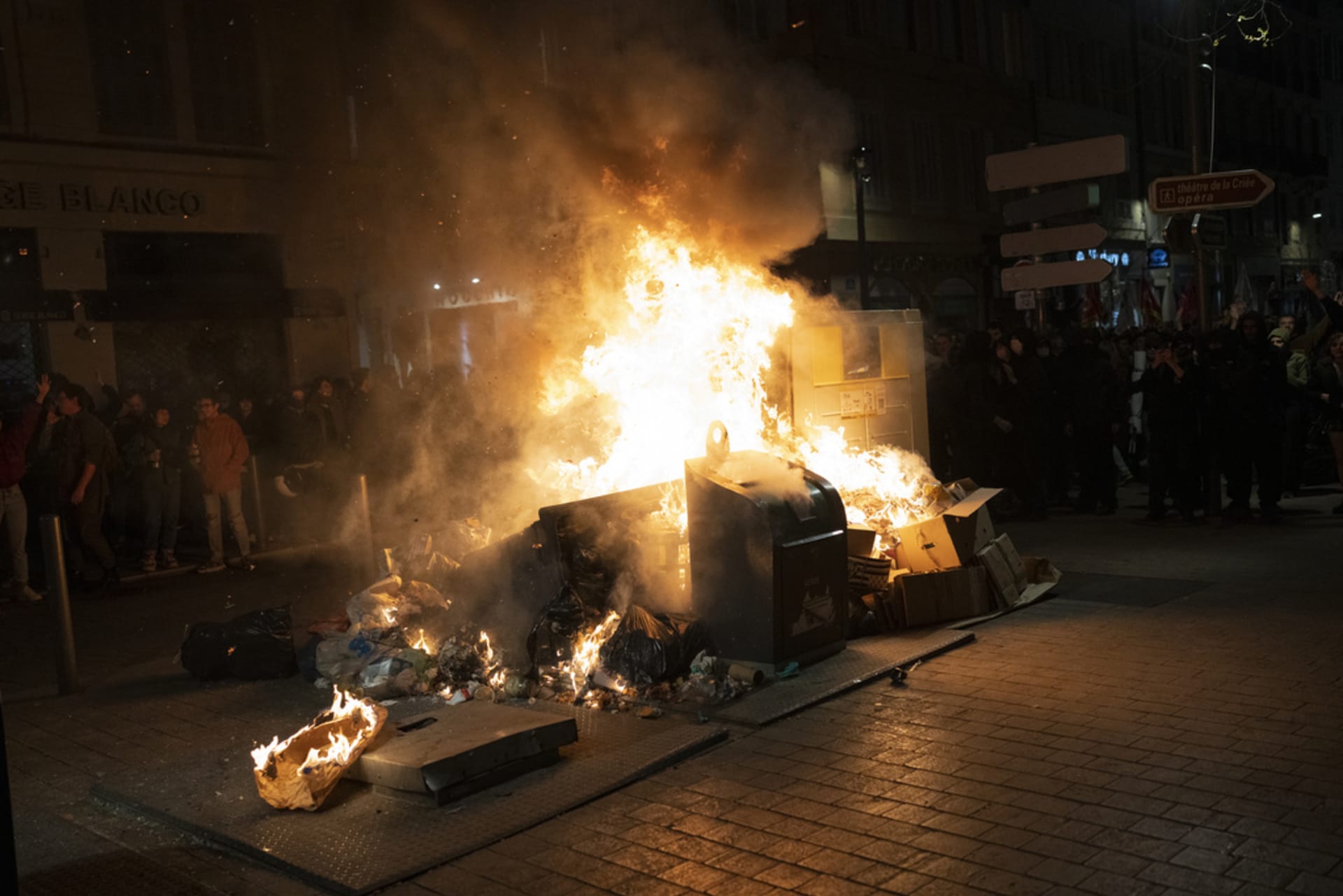 Protestující zapalují kontejnery na odpadky během demonstrace v Marseille na jihu Francie, čtvrtek 16. března 2023.