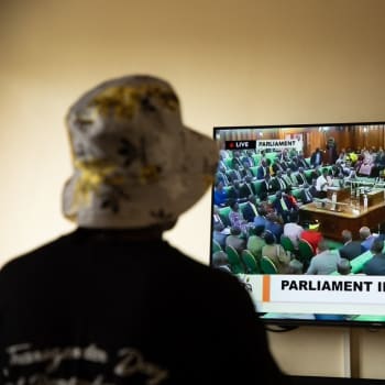Transgender žena, která se kvůli napadení skrývá, sleduje jednání ugandského parlamentu, který schvaloval zákon namířený proti gayům a dalším sexuálním menšinám