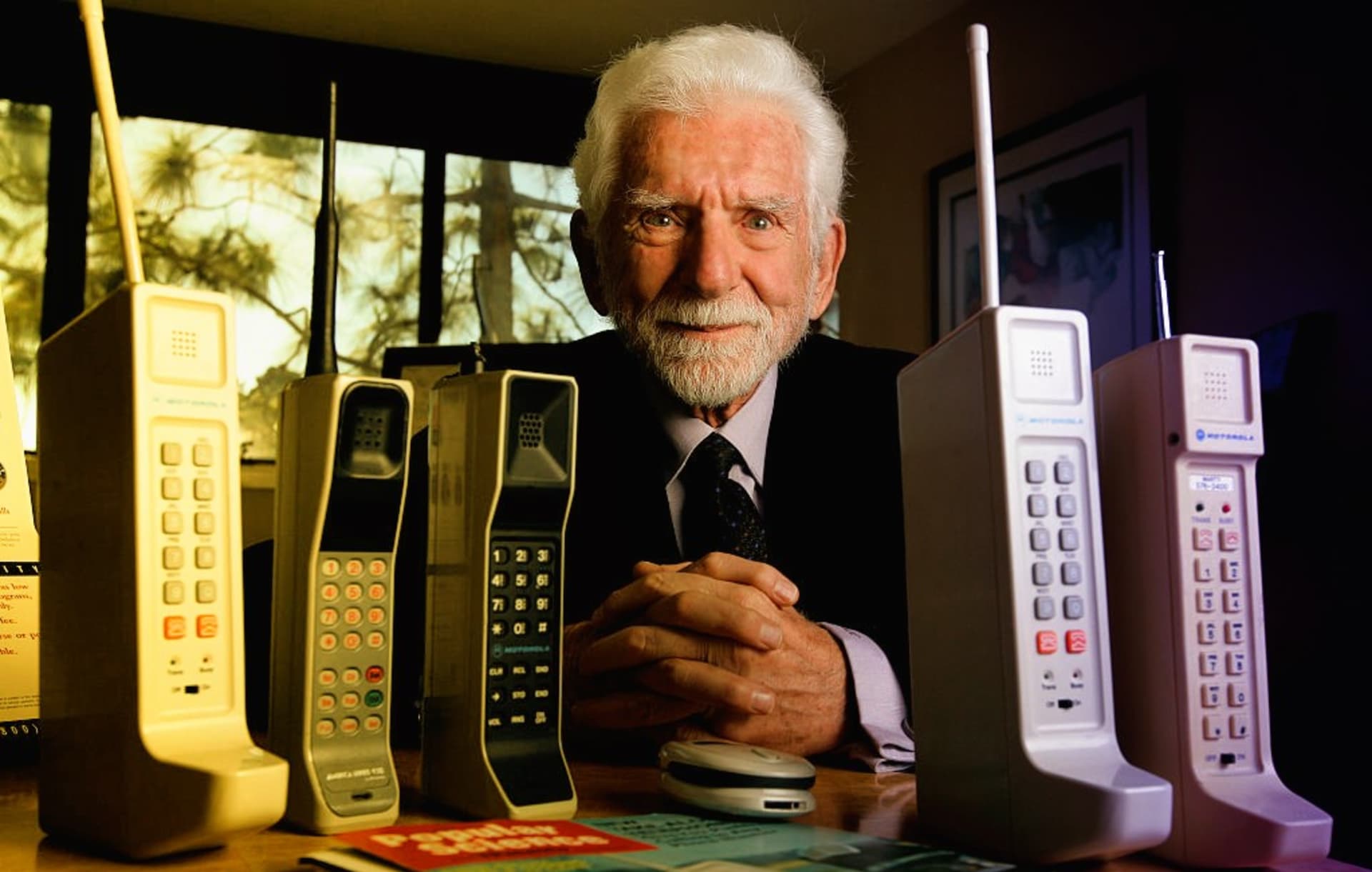 Vynálezce Martin Cooper s různými verzemi prvního mobilního telefonu Motorola DynaTAC