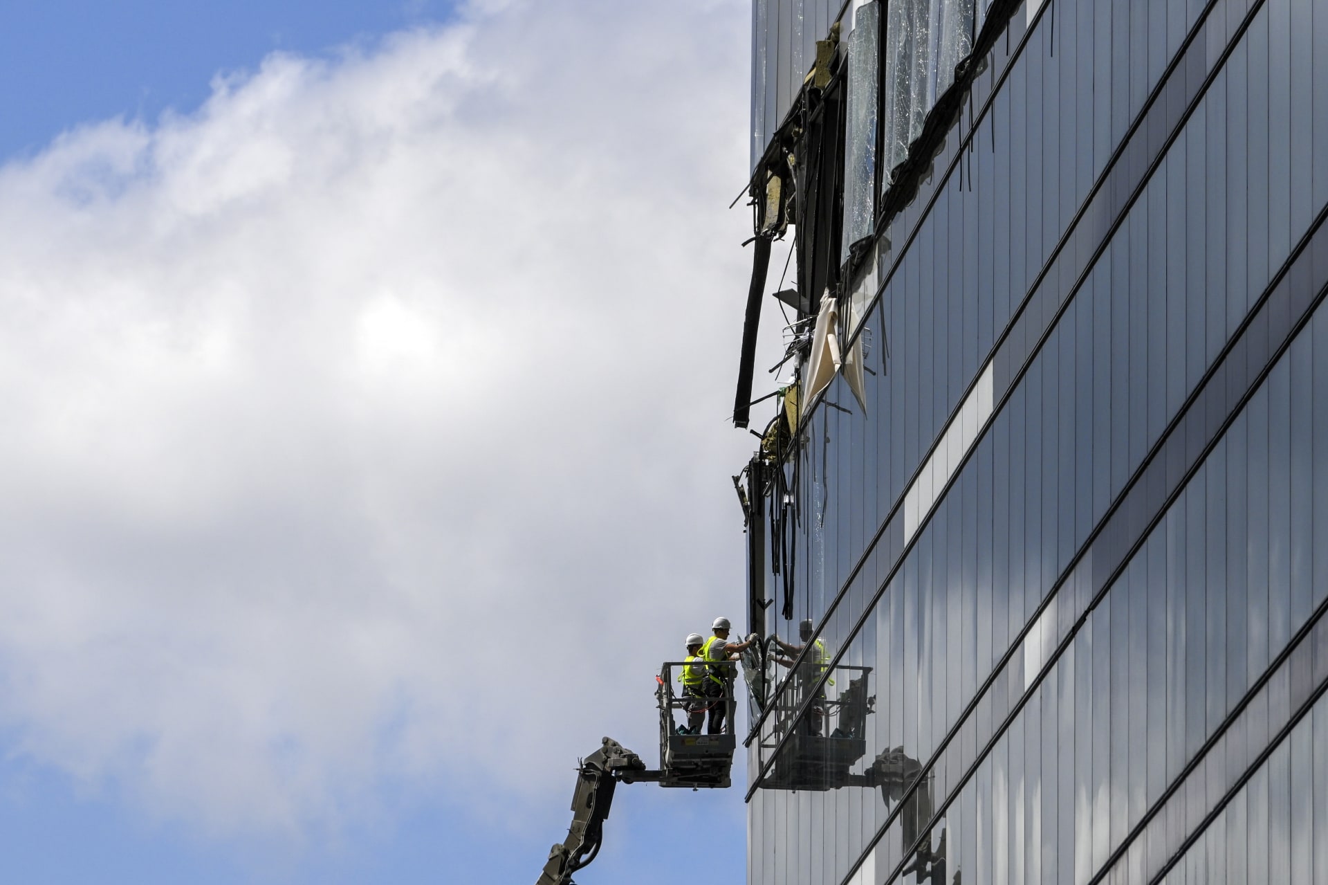 Pracovníci odstraňují trosky z poškozeného moskevského mrakodrapu (30. 7. 2023).