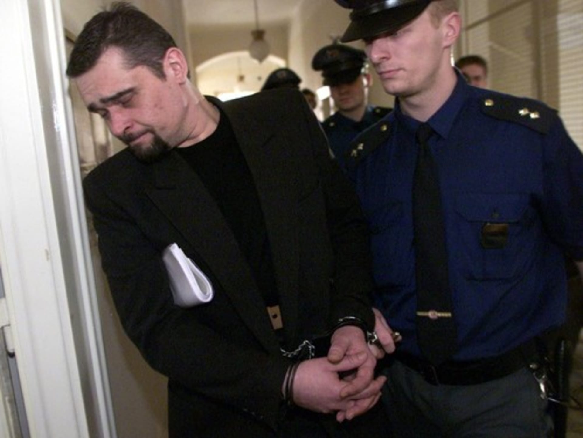 Balíkový vrah Martin Vostárek odchází od pražského městského soudu, který ho odsoudil ke 14 letům vězení.