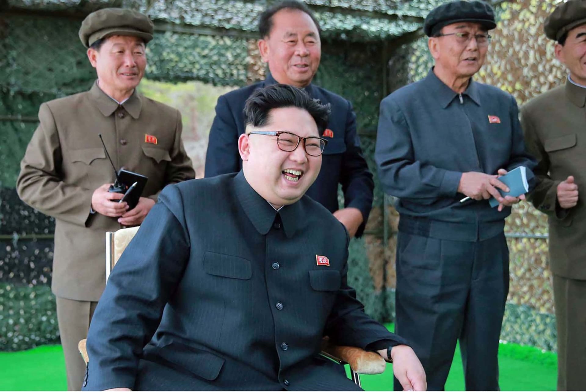 Kim Čong-un se směje při ukázce nových podmořských torpéd. (2016)