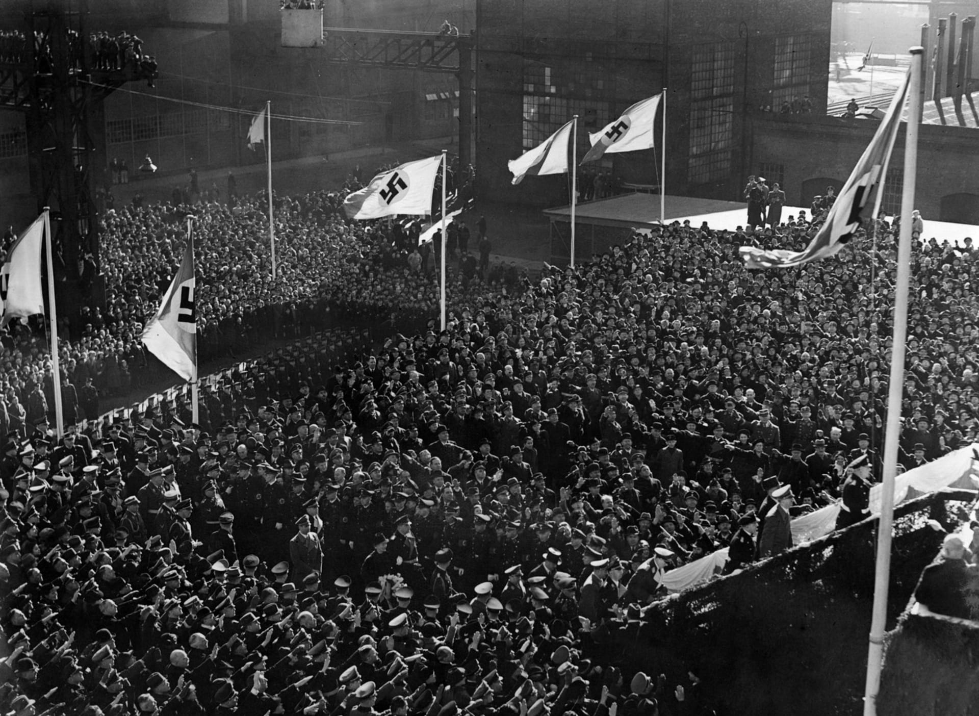 Adolf Hitler (vpravo) stoupá po schodišti, aby se před nadšenými davy zúčastnil pokřtění Bismarcku