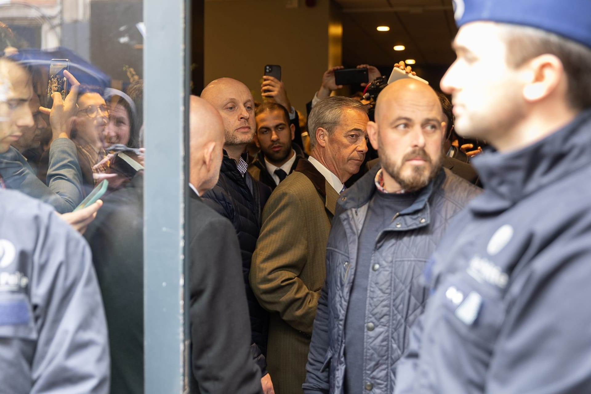 Britský politik Nigel Farage opouští budovu poté, co policie zablokovala vstup na konferenci o národním konzervatismu v hotelu Claridge v Bruselu, úterý 16. dubna 2024.